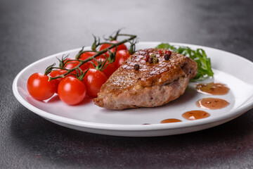 Baked duck breast with herbs and spices on a dark concrete background
