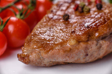 Baked duck breast with herbs and spices on a dark concrete background