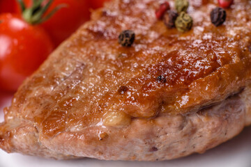 Baked duck breast with herbs and spices on a dark concrete background