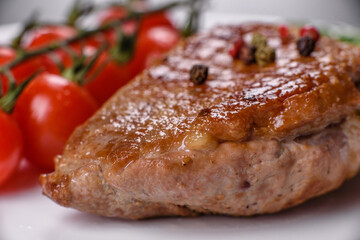 Baked duck breast with herbs and spices on a dark concrete background