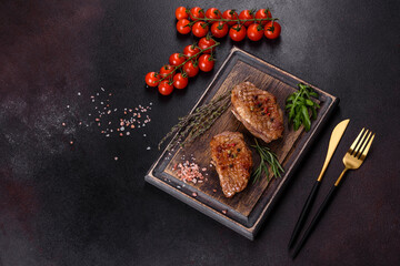 Baked duck breast with herbs and spices on a dark concrete background