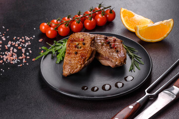 Baked duck breast with herbs and spices on a dark concrete background
