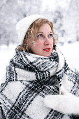 Winter portrait of a woman in a white hat and gloves