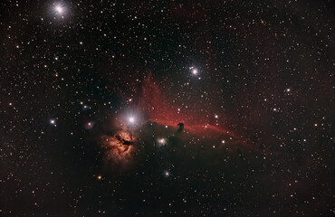 flame and horse head nebula in the orion constellation surrounded by h alpha dust in deep space taken with modified dslr camera © heidi