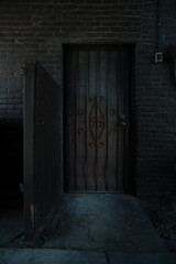 Fototapeta na wymiar dark creepy rundow back alley entrance locked wrought iron gate downtown yakima washington