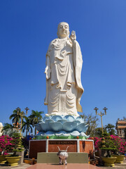 Standing Buddha Statue at the Vinh Trang Temple in Mytho City. Mekong Delta, Vietnam. Translation: "I place my faith in Buddha."
