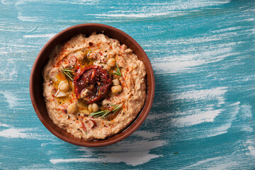 vegan food. hummus with sun dried tomatoes and smoked paprika