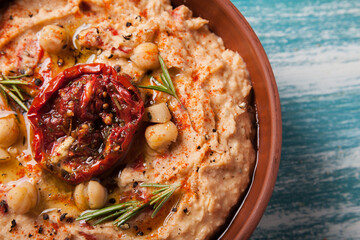 vegan food. close-up hummus with sun dried tomatoes and smoked paprika