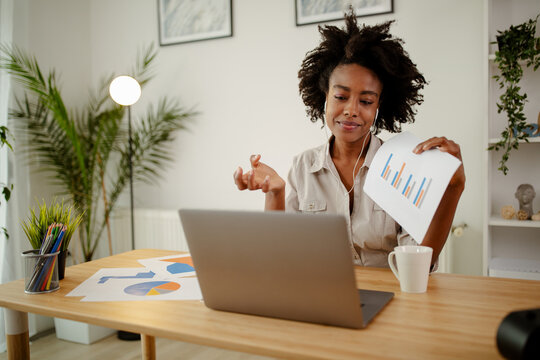 Businesswoman holding documents with financial statistic.