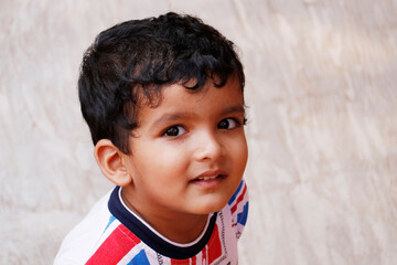 young  indian baby boy in close up with white background