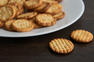 Round small salty bisquits on white plate