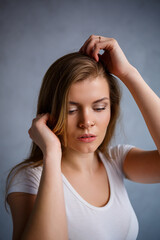 Obraz premium Close up portrait of a beautiful young woman. Emotional photo of a girl. Dressed in a white t-shirt