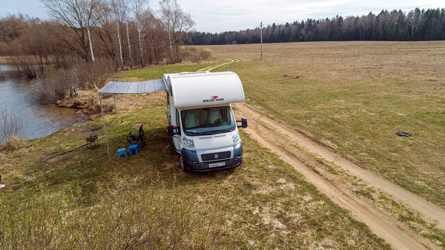 Fiat Ducato. Motorhome. Roller Team Zefiro Garage (Alcove). cloudy winter day. RV in Spring lake and field background. Moscow Oblast, Russia 04.19.2021