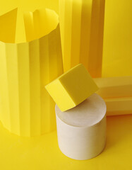 Podium in yellow color with geometric shapes. Stage with concrete, plaster geometric shapes.
