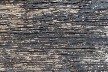 Old wooden abstract background texture surface with peeling black paint texture.