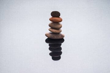 Stones stacked on top of each other with reflection. Balance and stability, concept