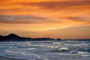 Yaquina Head lighthouse at sunset near Newport Oregon on the Oregon coasat.