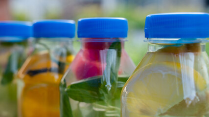Variety of detox water on a plastic container, health concept