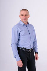 Man in blue shirt and black trousers on white background