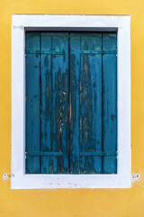 Obraz na płótnie Canvas Colorful window of a house on the Venetian island of Burano, Venice. Facade of the houses of Burano close-up. Venice, Italy.