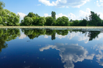 Sun over calm river in the spring morning