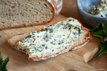 Slice of bread with a herbal spread made from butter and young nettles in spring