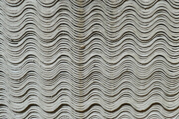 Dangerous asbestos as building material for roof covering. In many countries this material is due to cancer risk from microfibers banned. Here new stacked roof panels in the form of waves in Brazil.