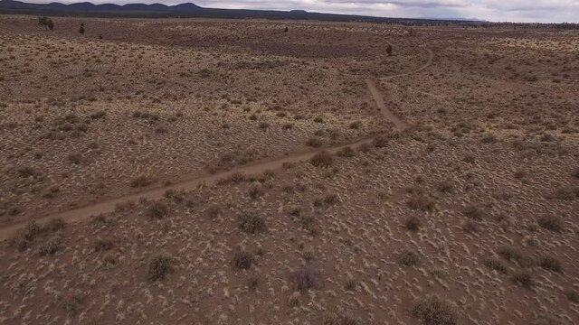 2 ATVs and 2 dirt bikes riding desert trails, Bend, Oregon