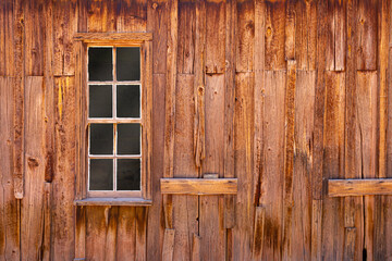 Obraz na płótnie Canvas Rustic wooden exterior wall with a framed window