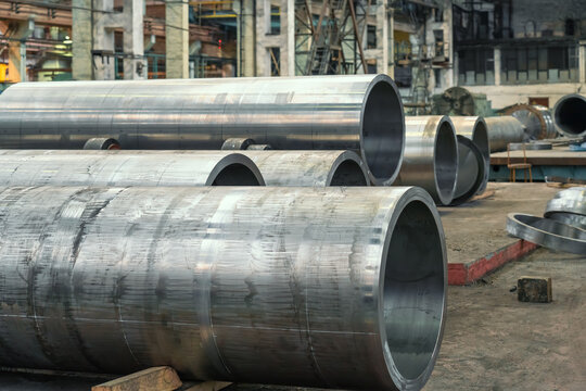 Large diameter metal pipes in metalworking workshop at factory.