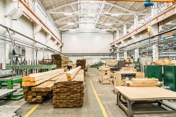 Inside huge factory workshop interior with stacks of wood for making molds.