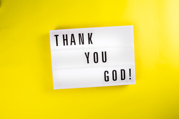 Lightbox with text message THANK YOU GOD isolated on yellow background. Concept of happiness, prayer, faith, hope, gratitude, gratefulness, survive, luck, chance, godsend, pleased, Thanksgiving Day