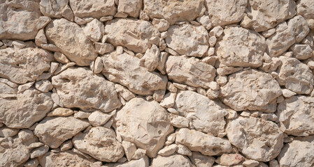 Detail of a stone wall with different size of rocks. arabic style wall.