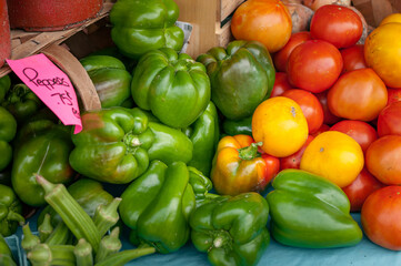 Green peppers and a variety of colorful tomatoes at the market.