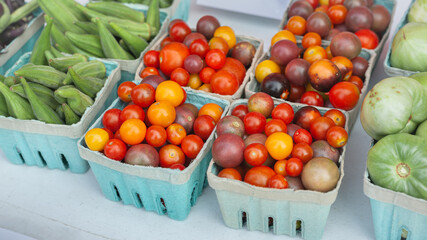 Cherry tomatoes, green tomatoes and okra on sale at the market.