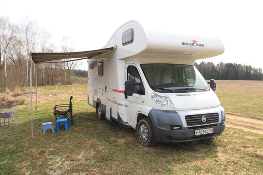 Fiat Ducato. Motorhome. Roller Team Zefiro Garage (Alcove). cloudy winter day. RV in Spring lake and field background. Moscow Oblast, Russia 04.19.2021