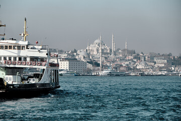 Fototapeta premium Turkey istanbul 03.03.2021. Pedestrian ferry with magnificent istanbul city and grand mosques established by ottoman empire background during early in the morning 