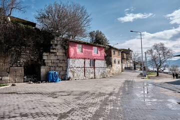 Fototapeta premium Bursa Turkey 29.01.2021. Golyazi and uluabat lake with countryside and old vintage pink color house in rural scene with huge and blue sky and white clouds background.