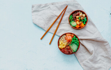 Poke bowl, traditional Hawaiian raw fish salad with rice, avocado, cucumber and radish