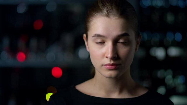 Portrait of serious young woman nodding head with positive gesture indoors. 