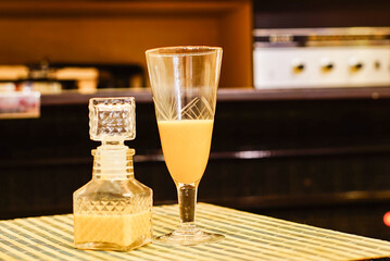 old glass with milk liquor, old glass vessel and turntable