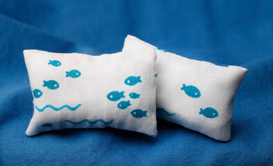 Cushions with fish on blue background