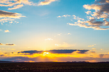 Sunset in the village on the field.