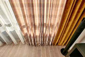 Interior curtains in yellow shades with a bright sun outside the window