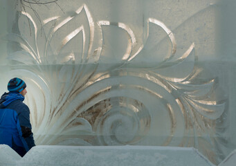 The sculptor carves a graceful composition on the ice panel
