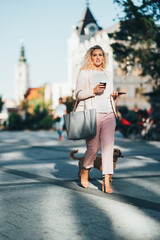 Woman walking down the street with dog