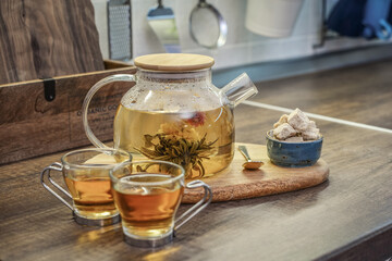 Fototapeta premium Blooming flowering tea in glass teapot