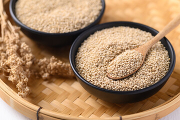 Brown quinoa seeds in a bowl with spoon, Edible seeds are high protein, Healthy food