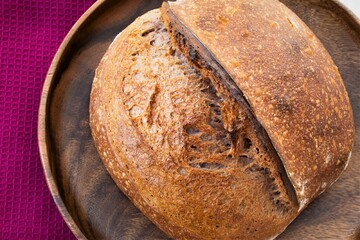 loaf of homemade bread on wooden plate