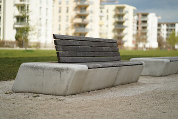 Selective focus of urban abstract wooden benches installed in stone formations